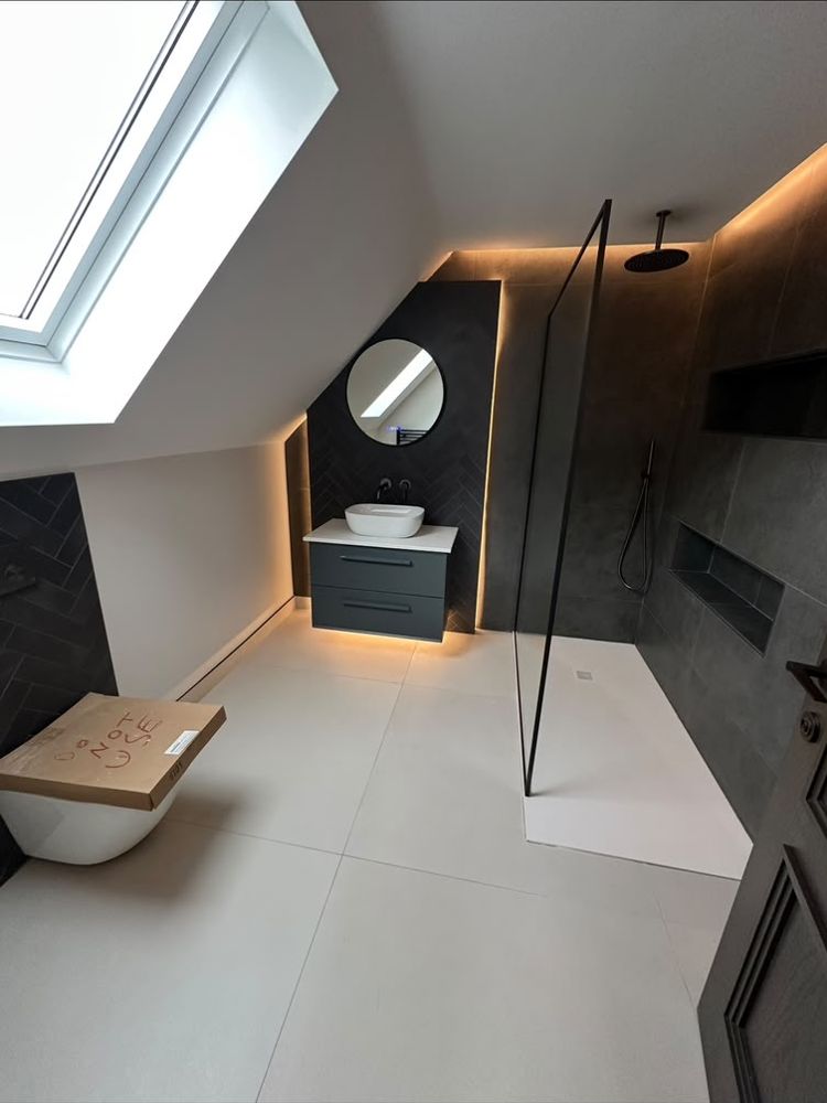 Loft bathroom with dark tiles, LED lighting, floating vanity and walk-in shower