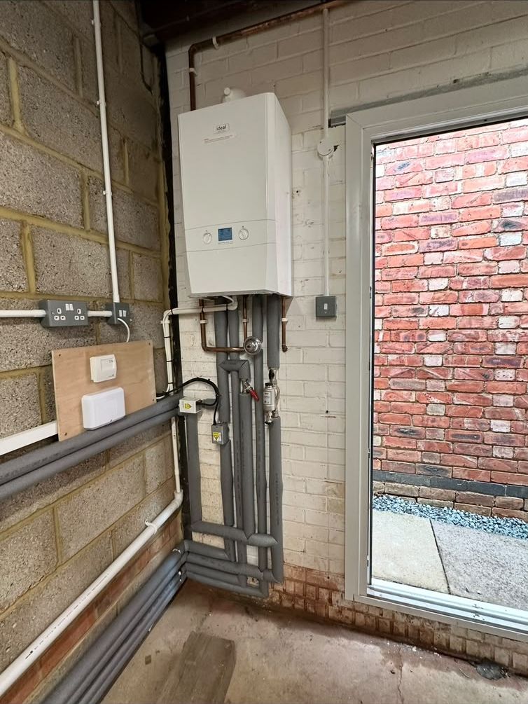 Ideal boiler fitted in a utility room with insulated pipework