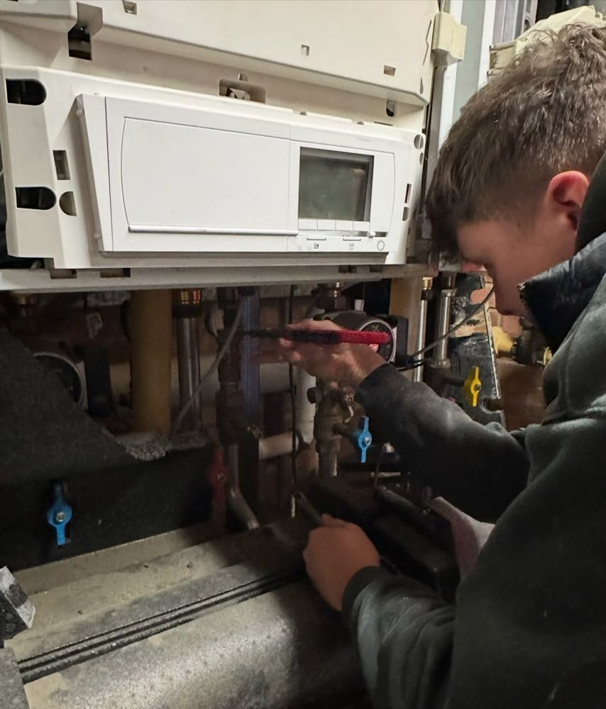 George working on a boiler with the case removed