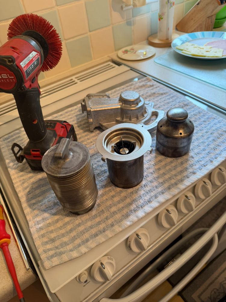 Boiler burner parts removed and laid out on a towel for cleaning